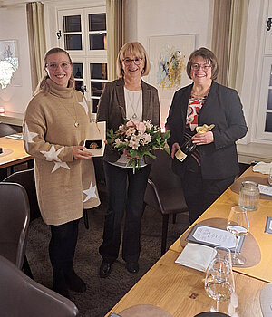 Marina Trommer (left) and Karin Gremminger-Trommer (right) bid farewell to Monka Gal as she enters retirement with gifts.